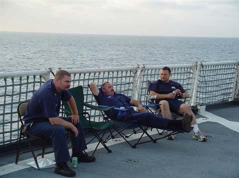 Figure 2: SKC Keyes, HSCS Gordon, and LTJG Kowalczyk Awaiting a Flight Deck Movie 2. The day after we got underway, bingo was held on Saturday per our typical Saturday night routine.