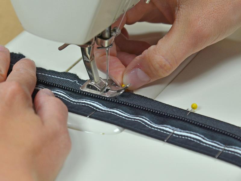 Sew the zipper onto the webbing.