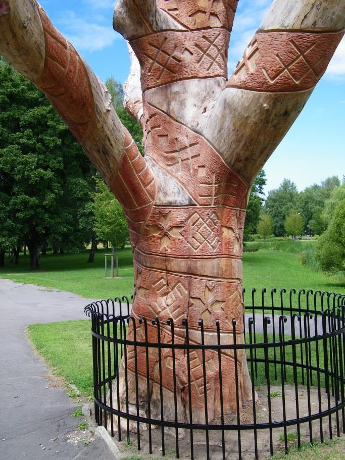 sculpture carved with a variety of Latvian folk symbols (right).