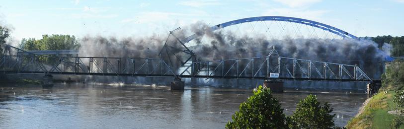 At right, sections of the bridge are removed from the river after the blast. A second blast took place on Oct. 11 to remove bridge pier 9 on the Kansas side. The final blast is scheduled for Oct.
