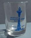 Lot # 324 - Shot Glass with Blue picture of the "Space Needle", "Seattle World's Fair 1962". Size: 2 3/8" tall by 1 7/8" diameter. Condition: Excellent.