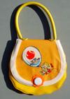Lot # 402 - Vinyl child's purse with the logo in a balloon being held by 2 children on the front.