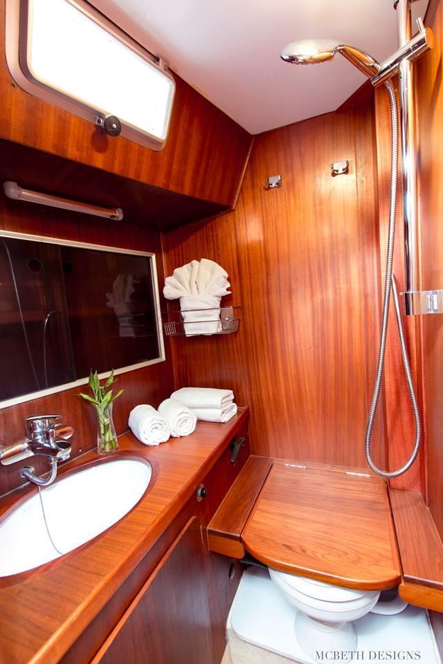 Aft is a spacious master stateroom with private large ensuite with head and vanity basin and shower.