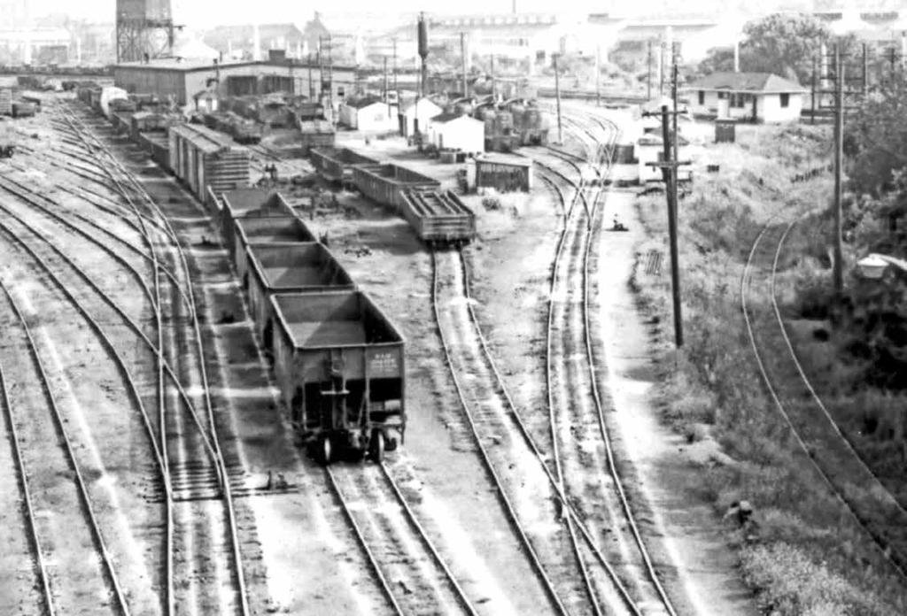 Same photographer, same site, panned slightly right to show the engine house, servicing facilities, shop track and a clutch of Alco switchers.