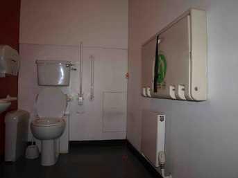 On the first floor, there is a unisex accessible toilet with handrails and a