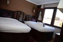 single beds, view window, and private en suite bathroom.