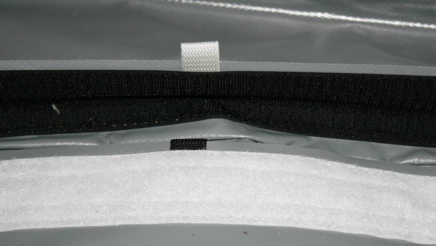 of the floor where the Velcro is marked with white and black dots.