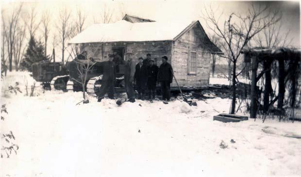 Amanda, Hildegard and Walter Kuse in Front of Little House Then the log house was sold to the Ted Steffens and moved to Second Street in Medford.