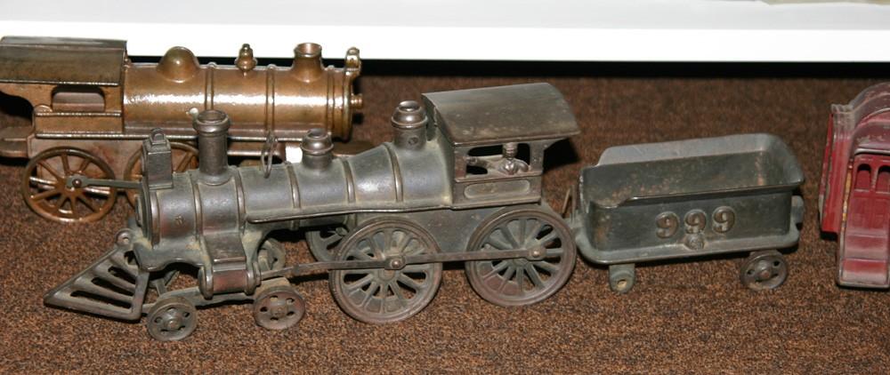 This cast iron pull toy locomotive is more elaborate than most, with a 4-4-0 wheel arrangement.