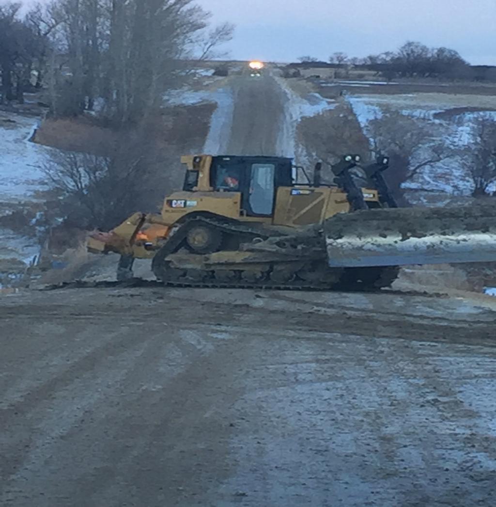 DOZERS RIPPING UP ROAD TO