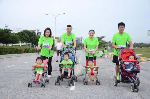 Parents with babies in strollers, enjoying family outing
