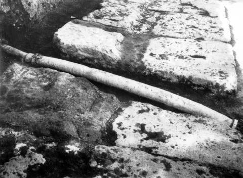 Fig. 12a,b. Kos, Western Gymnasion: a. a clay Hellenistic pipe that goes through the foundation of the northern side of the building; b.