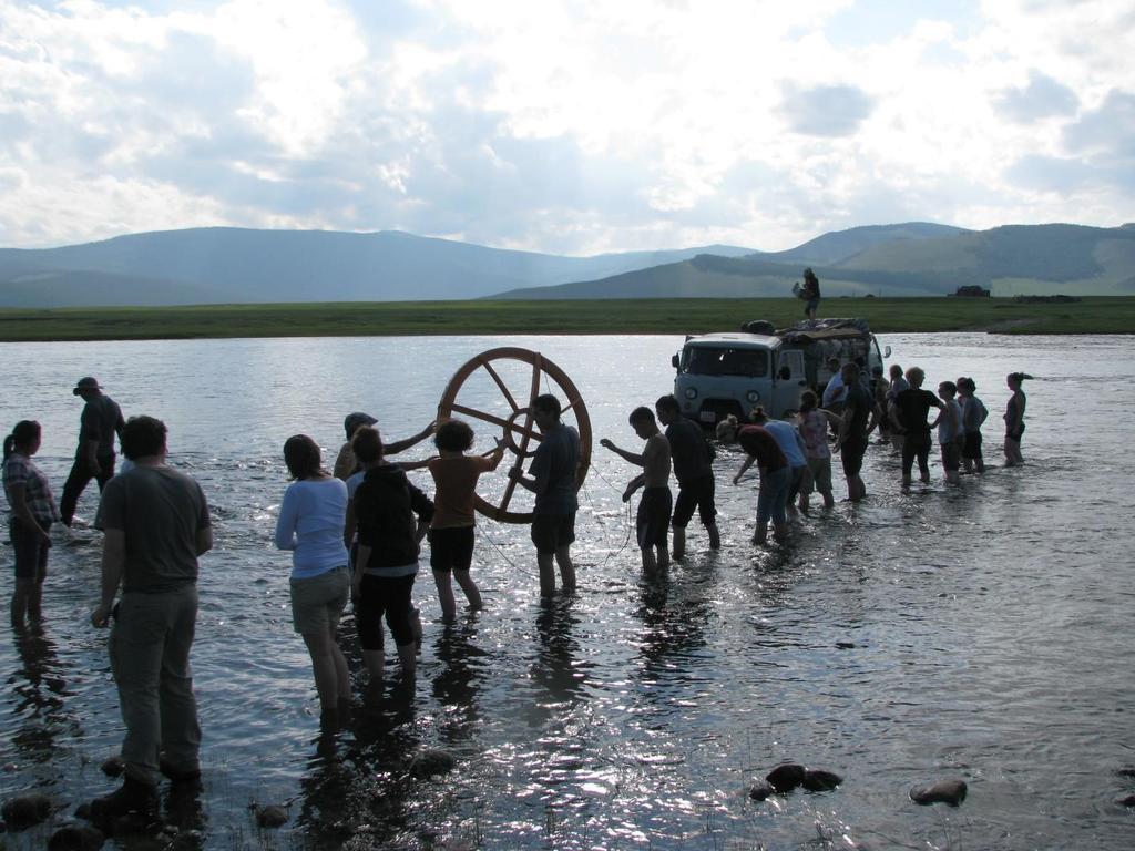 PARTICIPANTS IN THE 2012 PROJECT WORK TOGETHER TO UNLOAD A TRUCK THAT GOT STUCK WHILE CROSSING THE RIVER Requirements: No previous archaeological experience necessary to participate in this project.