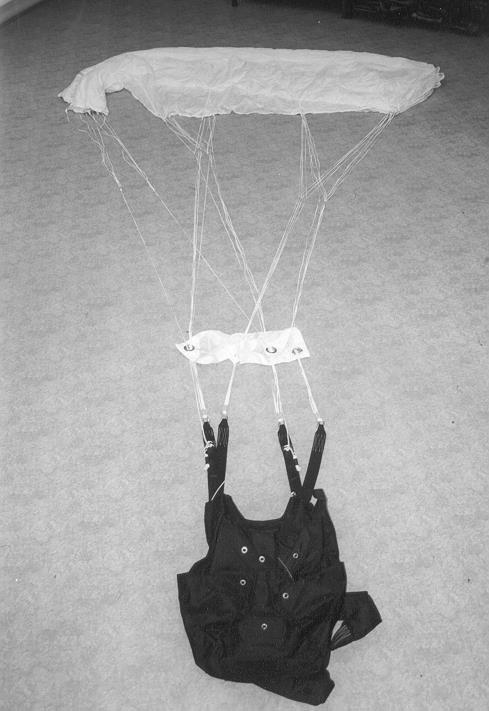 2. The supporting harness is to be attached to the edge of the packing board and the parachute canopy is then to be unfurled over the surface of the board, as shown in picture No. 2.