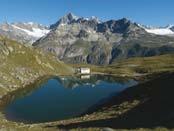 This idyllic lake has reflections of the surrounding mountain scenery.