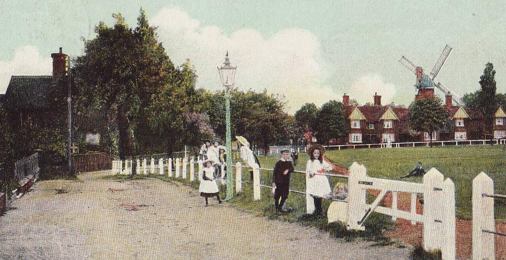 It was designed by William Caroe and opened in 1892 by the Prince of Wales. This photo dates from that era. Follow the road round to the left, where it narrows before returning to Blythwood Gardens.