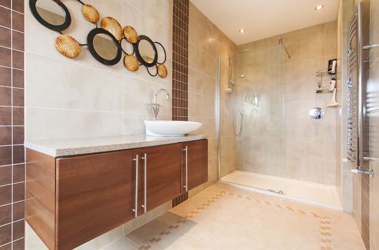 window, utility room, impressive principal lounge with glass feature wall, stunning views and doors to a large decked area, 3 double bedrooms, 2 en-suite shower rooms, principal bathroom with