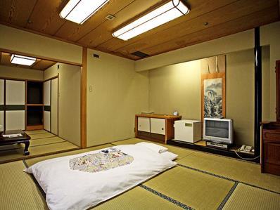Room in Ryokan Yukata Onsen hot spring Washing space Traditional Japanese room does not have bed, instead, it has Futon mat on "Tatami" straw weaving floor to sleep on.