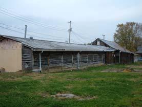 Attached to the south wall of the livery barn/garage is a long rectangular building on a poured concrete foundation and rustic wood lapped siding. It dates to about 1975. 008 [60] W. Washington St.