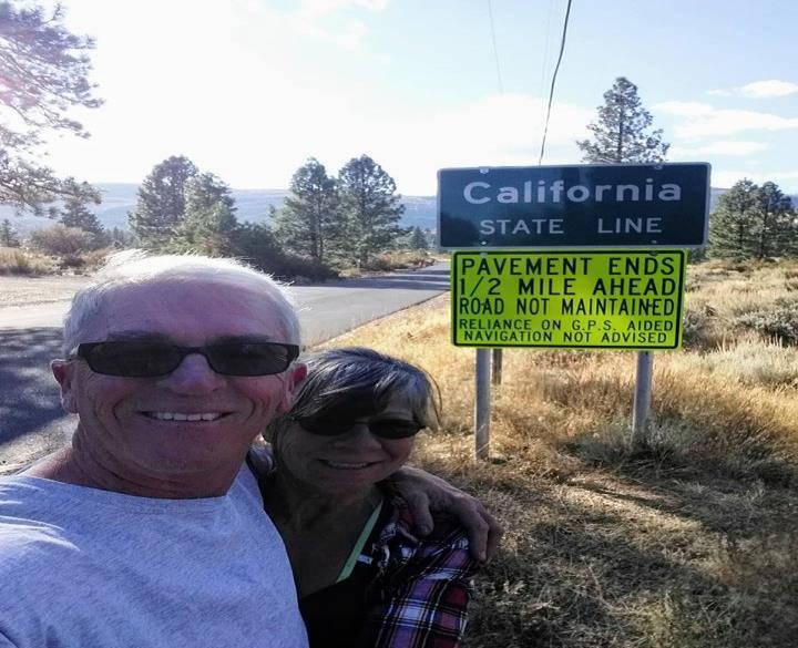 Monica and I standing on The First-Generation Lincoln Highway, Dog Valley Road. That sign is for real!