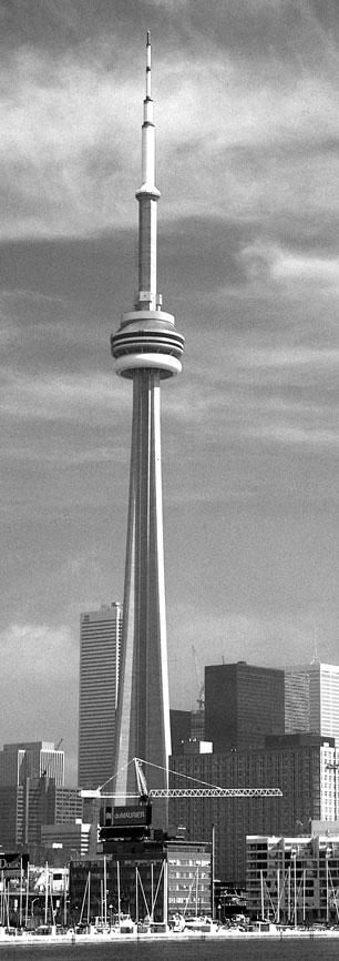Canadian National Tower Next we cross the Atlantic Ocean from the Netherlands to Toronto, Canada, where visitors can stand on an observation deck of the Canadian National, or CN, Tower and see