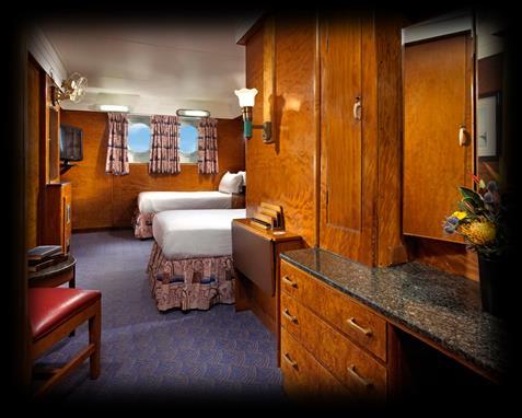 Includes: operable portholes that face the port side of the ship, seating area with (2) chairs and a table. Deluxe Two-Twin: Equipped with (2) twin beds.