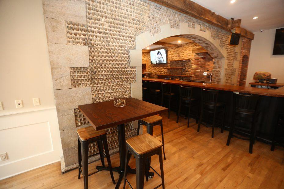 Over the bar, you can see the exposed original cobblestone wall from 1844 that has been preserved.
