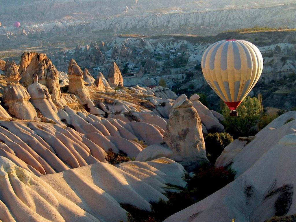 The best historic mansions and cave houses for tourist stays are in Ürgüp, Göreme, Güzelyurt, and Uchisar. Hot-air ballooning is very popular in Cappadocia and is available in Göreme.