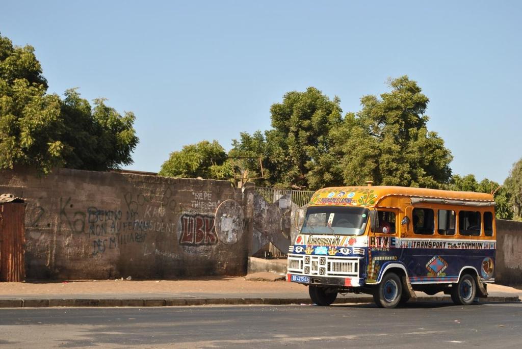 174 Consilience Photo 2: An old car rapide. Dakar, Senegal. The main thoroughfare in Guediawaye, a slum of Dakar, is covered in polluted water.