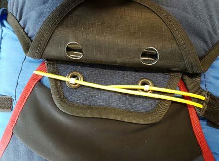 The yellow cable locks the reserve parachute pocket flaps in place