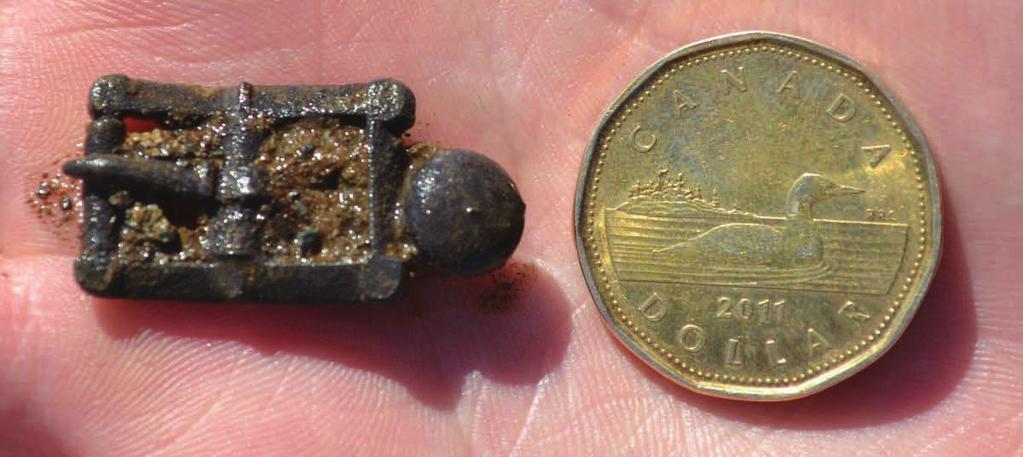 Figure 2. Silver shoe/spur buckle, with Loonie for scale. with the later 18 th - to 19 th -century reoccupation.
