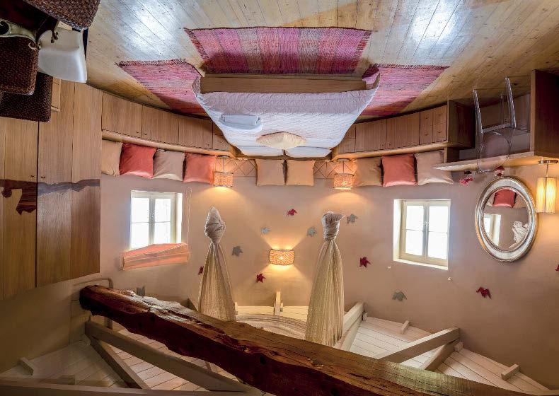 From its barrel shape adorned with the flour mill s original sail structure, to the high ceilings and the wooden crossbeam inside, Villa Milos is a unique place for an island