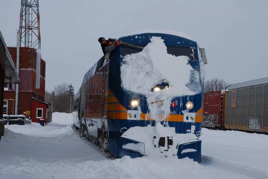 Engineman by passing him the broom in the attempts to clear the windshield. Under the snow was VIA #903!