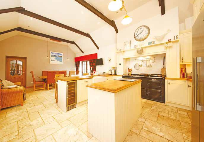 Spacious and well appointed combined 26 x 15 kitchen and dining room. Bespoke designed kitchen centred around an Aga with a full complement of floor and wall mounted cabinets.