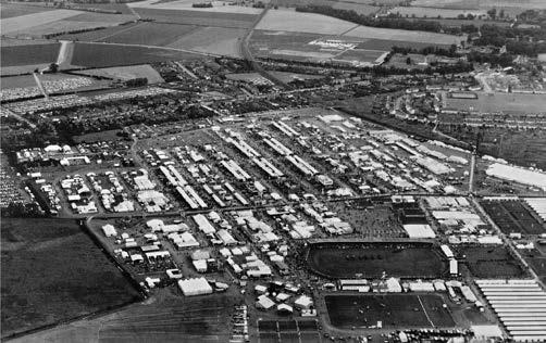 D. The Royal Showground Aerial view of the 1961 Royal Show, located on the farmland between the London railway line and Shelford Road, with the Cambridge- Bedford railway cutting and the estate to