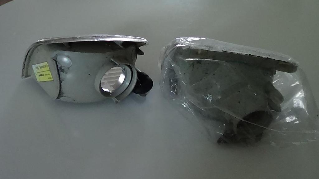 Exhibit 13: Seat Arosa Mark I Passenger Side Indicator Light A grey object was spotted in the Preparation Area with a round hole. The object had a Made in Spain mark but no part identification number.