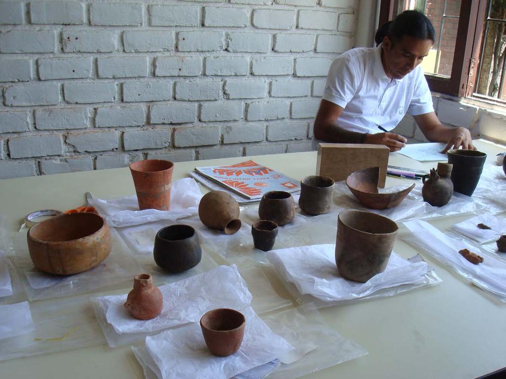 Artist drawing whole and near whole ceramic vessels