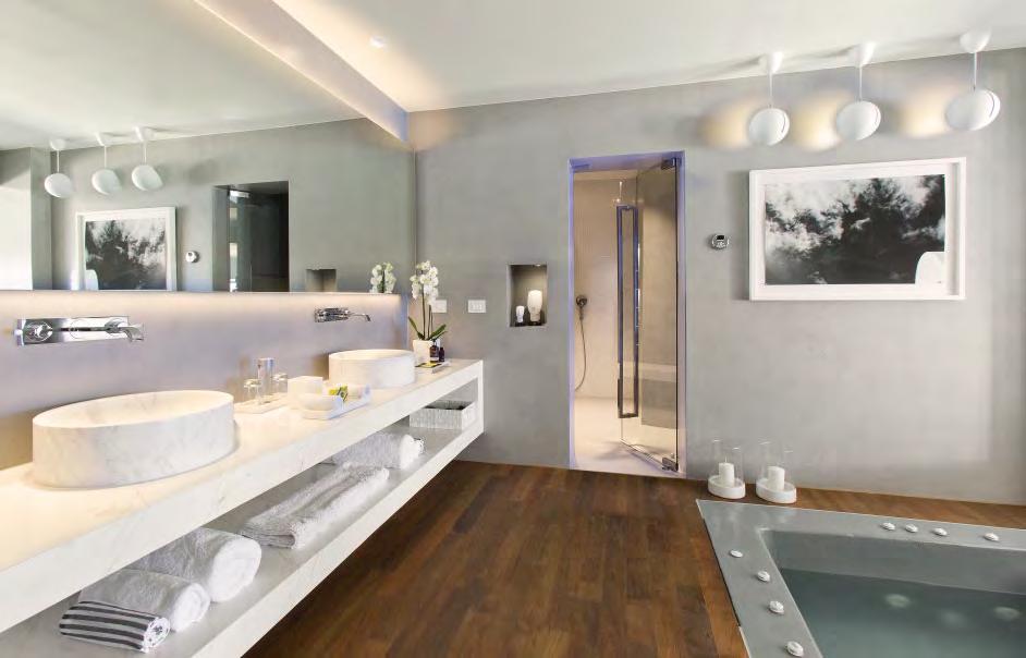An ultra-luxurious en-suite bathroom features a steam bath and an interior heated plunge pool featuring views of the horizon.