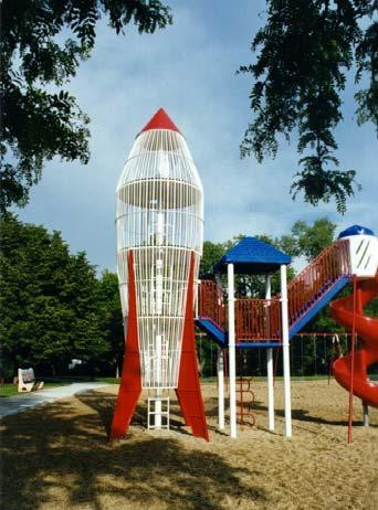 A 1970 s playground climbing frame in the shape of a rocket is a favorite feature of the park; Play Environments redesigned the park around this feature and added space elements in adjacent play
