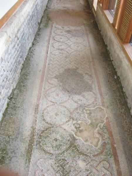 Mosaic floor in main gallery along front of building.