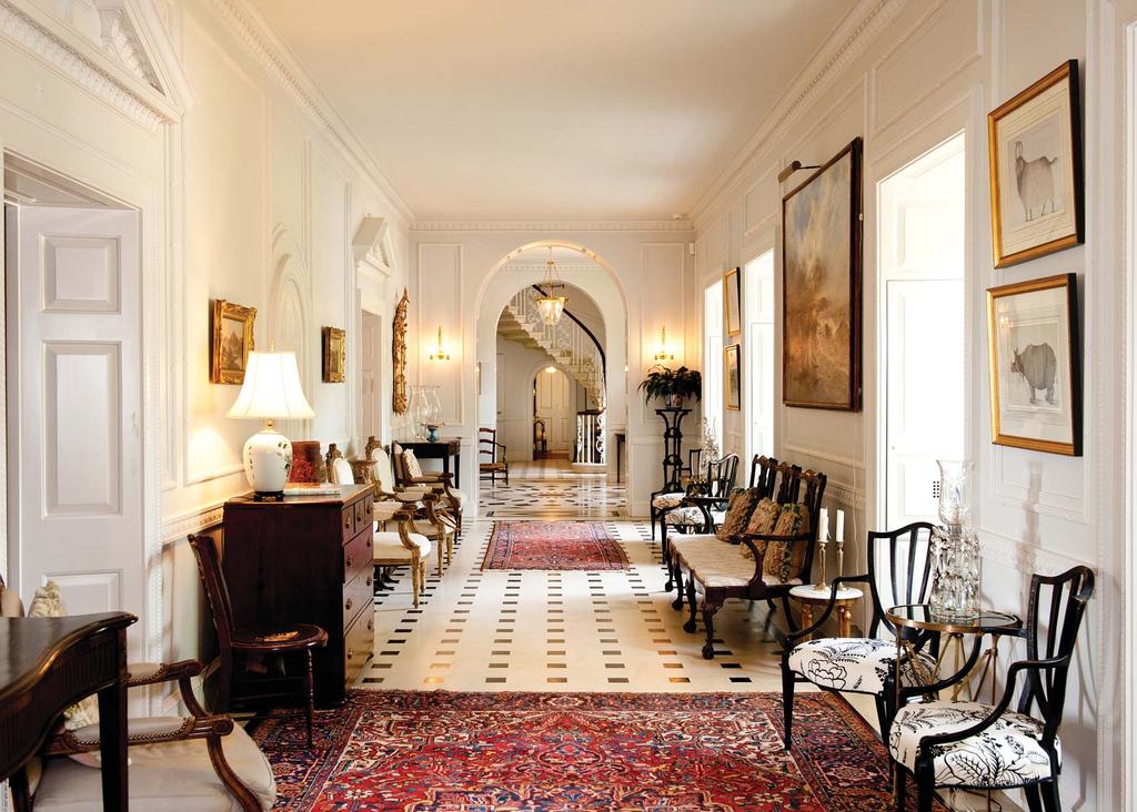 intricately laid marble flooring with black inlays and delicately carved trim and molding.