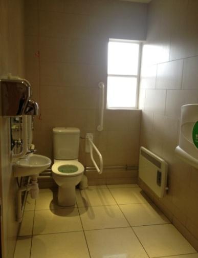 There are two cubicles and two hand basins and an automatic hand dryer. An arm chair is provided.