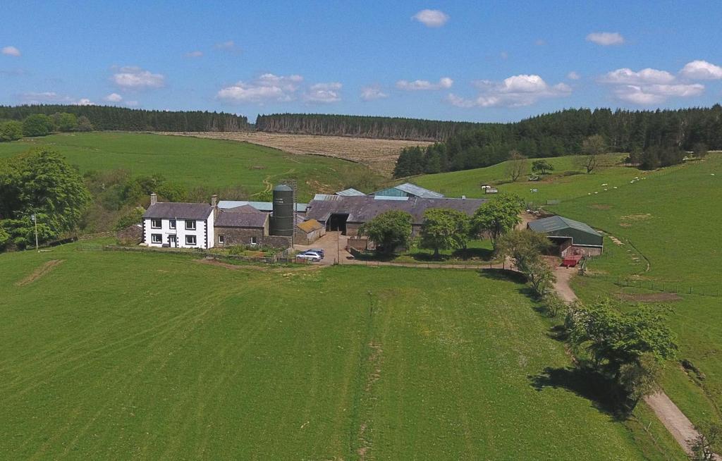 four bedroom farmhouse (EPC=F), with an extensive range of farm buildings with over 400 acres of silage ground and improved