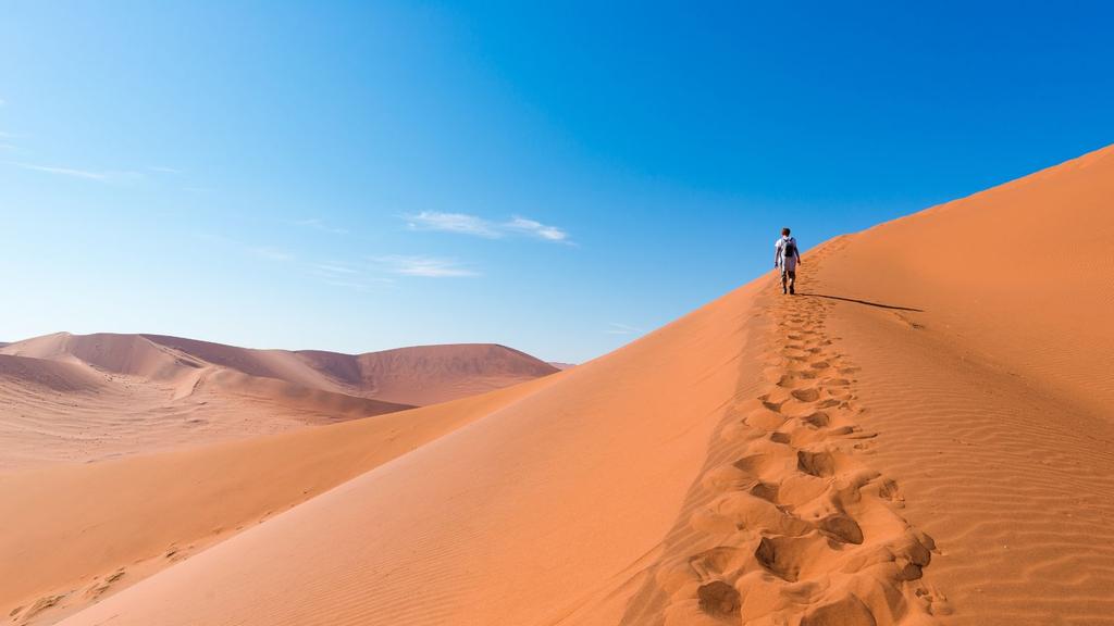 After a night spent in the country s engaging capital, you ll journey through the haunting landscapes of the Namib Desert, where you can climb to the top of the towering dunes of Sossusvlei.