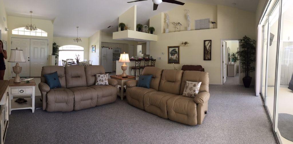 * Huge open living room with high ceilings and one whole side ( over 20 feet) of sliding glass doors, that opens to the lanai and invites the outside in!