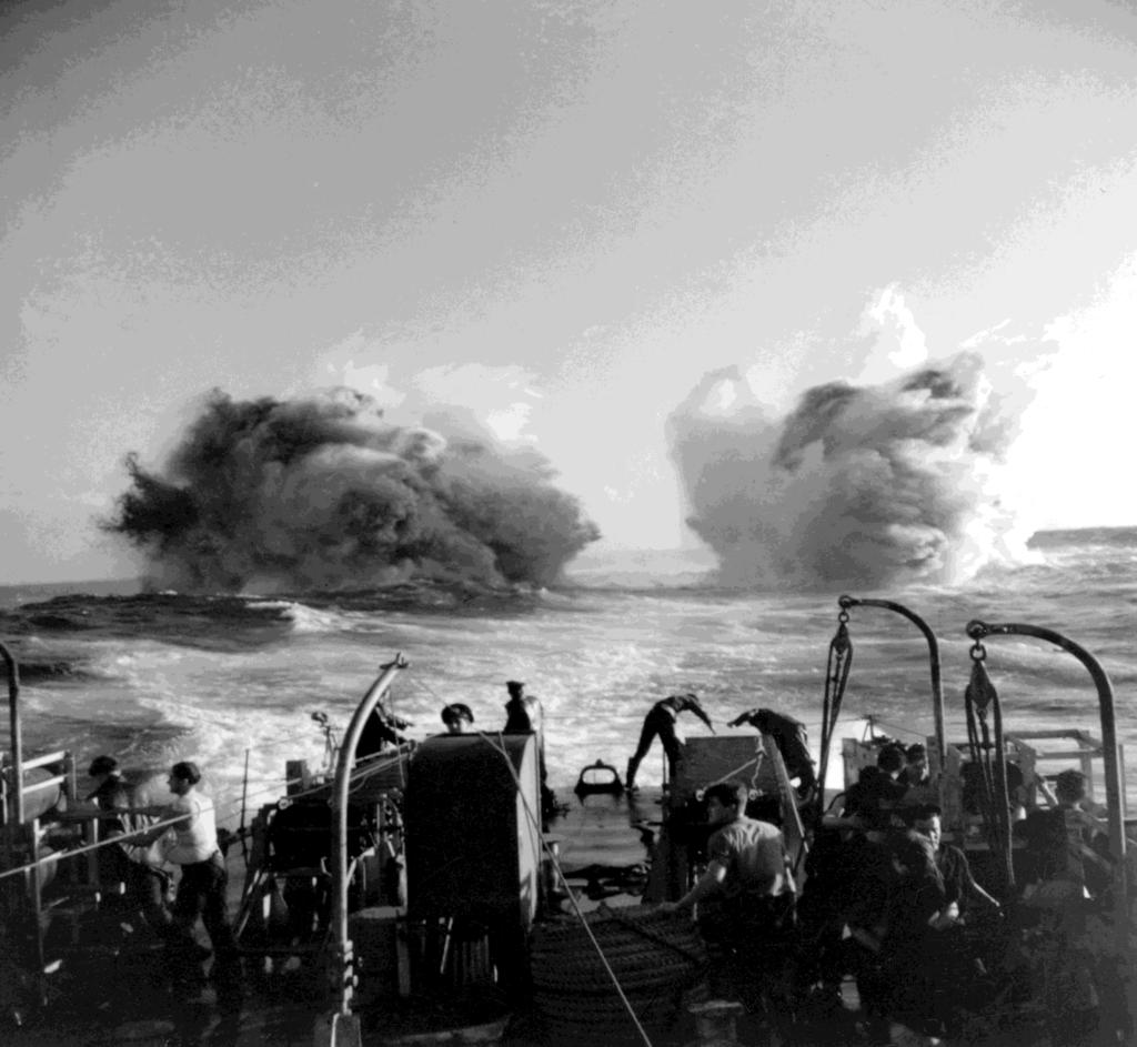 Depth Charge Attack from the Stern A depth charge pattern dropped from the stern racks of a Canadian frigate detonates in this photograph by G.A. Lawrence taken in January 1944.