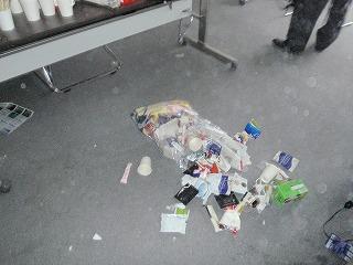 A bag of trash fell from a table onto