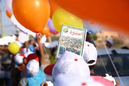3 Youths launch balloons at the opening ceremony. Slips of paper are attached to the balloons with the names of the camps and of the cities and villages the Palestinians fled from in 1948.