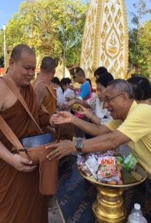 to monks at Wat Pra That Nong Bua in Muang