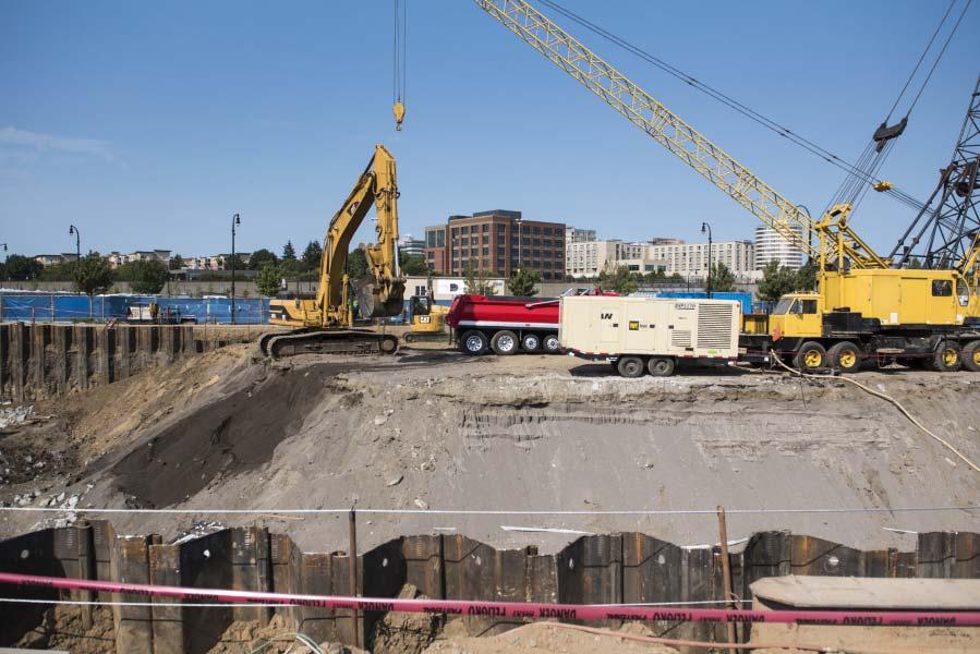 Excavators work to remove dirt at the future site of Hotel Indigo along The Waterfront